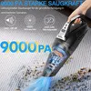 A hand holding a black handheld vacuum cleaner on a carpet, with debris being sucked up. Produktbild-Vorschau