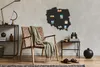 A living room scene with a chair, a map of Poland on the wall, and a side table. Podgląd zdjęcia produktu