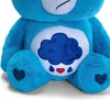 Close-up of a blue plush Care Bear toy. Produktbild-Vorschau