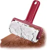 A baking roller with a patterned surface is shown pressing into a brown dough. Produktbild-Vorschau