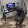 A gaming desk setup with a computer, monitor, and gaming chair in a room. Produktbild-Vorschau