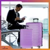 A man in a suit sits in an airport lounge with luggage. Náhled obrázku produktu
