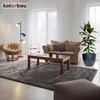 A cozy living room scene featuring a sofa, armchair, coffee table, rug, and a large potted plant. Náhled obrázku produktu