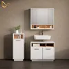 A modern bathroom vanity set with a sink, mirror cabinet, and storage units against a textured wall. Produktbild-Vorschau
