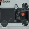 A close-up view of a black granite kitchen sink with a faucet and an apple in a drainer. Produktbild-Vorschau