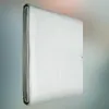 A folded silver tarp is shown in a studio setting with a blurred background. Produktbild-Vorschau