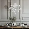 A crystal chandelier hangs above a dining table set for a meal. Anteprima dell’immagine prodotto