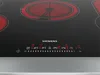 A close-up view of a Siemens induction cooktop with illuminated heating zones and digital controls. Produktbild-Vorschau