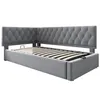 A corner view of a gray upholstered daybed with a tufted headboard and a slatted mattress base. Náhľad obrázku produktu