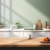 A white pasta drying rack stands on a wooden countertop in a kitchen setting. Produktbild-Vorschau