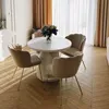 A dining table with four chairs is set up in a well-lit room with sheer curtains. Produktbild-Vorschau