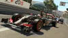 Two Formula 1 race cars on a track during a race, with advertising banners in the background. Produktbild-Vorschau