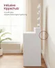 A white vanity table with LED lights is shown from the side, with a plant in a pot to the left and a window in the background. A safety strap is highlighted with a dashed circle. Produktbild-Vorschau