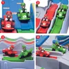 A collage of four images showing a Super Mario Kart Racing Deluxe toy set with Mario and Luigi characters in their karts on different track configurations. Produktbild-Vorschau