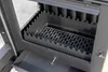 A close-up view of the interior of a wood-burning stove, showing the grate and ash pan. Produktbild-Vorschau