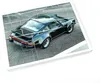 A dark green Porsche 911 Turbo is shown from a high angle, parked on a paved surface. The image is divided into puzzle-like pieces. Náhled obrázku produktu