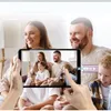 A family is watching something on a tablet while holding popcorn. Produktbild-Vorschau