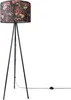 A floor lamp with a tripod base and a fabric lampshade with a floral jungle pattern. Produktbild-Vorschau