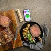 A cooked prime rib roast is presented on a cutting board and a plate, alongside a smartphone displaying a cooking thermometer app. Náhled obrázku produktu