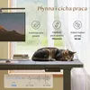 A cat sleeping on a standing desk in front of a window, with promotional graphics overlaid. Podgląd zdjęcia produktu