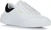 A white Skechers sneaker with black accents. Náhled obrázku produktu