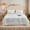 A cozy bedroom scene with a bed dressed in a colorful plush blanket. Produktbild-Vorschau