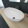 A white oval ceramic sink on a wooden countertop in a modern bathroom. Produktbild-Vorschau
