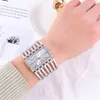 A woman's wrist wearing a silver watch. Produktbild-Vorschau