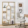 A gold and white bookshelf filled with decorative items and books, next to a desk and chair. Podgląd zdjęcia produktu
