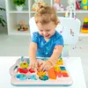 A baby is playing with a colorful interactive toy table. Podgląd zdjęcia produktu