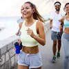 A group of people are jogging outdoors by the water. Produktbild-Vorschau