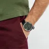 A person's arm wearing a watch, with their hand in their pocket. Produktbild-Vorschau