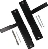 Two black door handles with their mounting hardware are arranged diagonally on a white background. Náhled obrázku produktu