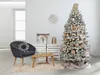 A decorated artificial Christmas tree in a room with furniture and decorations. Podgląd zdjęcia produktu