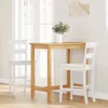 A wooden bar table with two white bar stools in a room with natural light. Náhled obrázku produktu