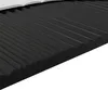 A close-up view of a black mattress topper with a white sheet on top. Produktbild-Vorschau