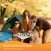 A family is playing a magnetic Xiangqi game outdoors near a tent. Produktbild-Vorschau