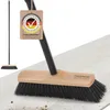 A broom is shown on a light-colored floor, with a small inset image of the broom standing upright. A tag is attached to the broom handle. Produktbild-Vorschau