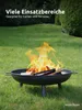 A black fire pit with a fire burning in it, placed on a green lawn in a garden setting. Produktbild-Vorschau