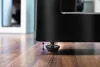 Close-up of a table leg with an adjustable foot on a wooden floor. Produktbild-Vorschau