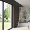 A modern interior with a staircase and a large window overlooking a garden. Produktbild-Vorschau