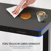 A hand wipes a spill from a desk surface next to a cup of coffee. The desk has a control panel and blue LED lighting. Náhled obrázku produktu