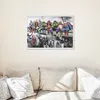 A framed painting of superheroes sitting on a ledge above a city is displayed on a wall above a sofa. Produktbild-Vorschau