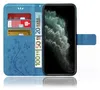 A blue flip case for a smartphone, showing credit cards and euro banknotes inserted into the case. Produktbild-Vorschau