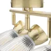A close-up view of a brass-colored ceiling spotlight with clear glass shades. Produktbild-Vorschau