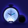 A close-up of a glowing alarm clock with a digital display. Produktbild-Vorschau