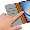 A hand is touching a smartphone in a flip case. Produktbild-Vorschau