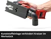 A hand holding a cordless jigsaw with a dust extraction attachment. Produktbild-Vorschau