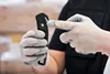 A person wearing work gloves is holding a MARTOR SECUMAX 350 safety knife and using their other hand to point at it. Anteprima dell’immagine prodotto