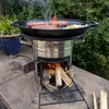 A BBQ-Toro cast iron plancha is being used to grill burgers and onions over a rocket stove with burning wood. Náhled obrázku produktu